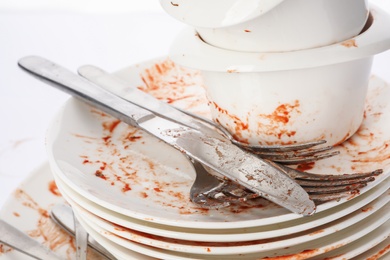 Pile of dirty dishes and cutlery, closeup