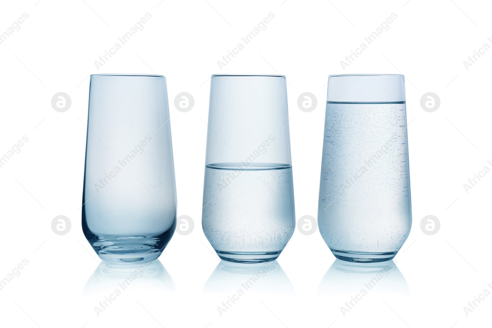 Photo of Empty, half full and full glasses of water on white background