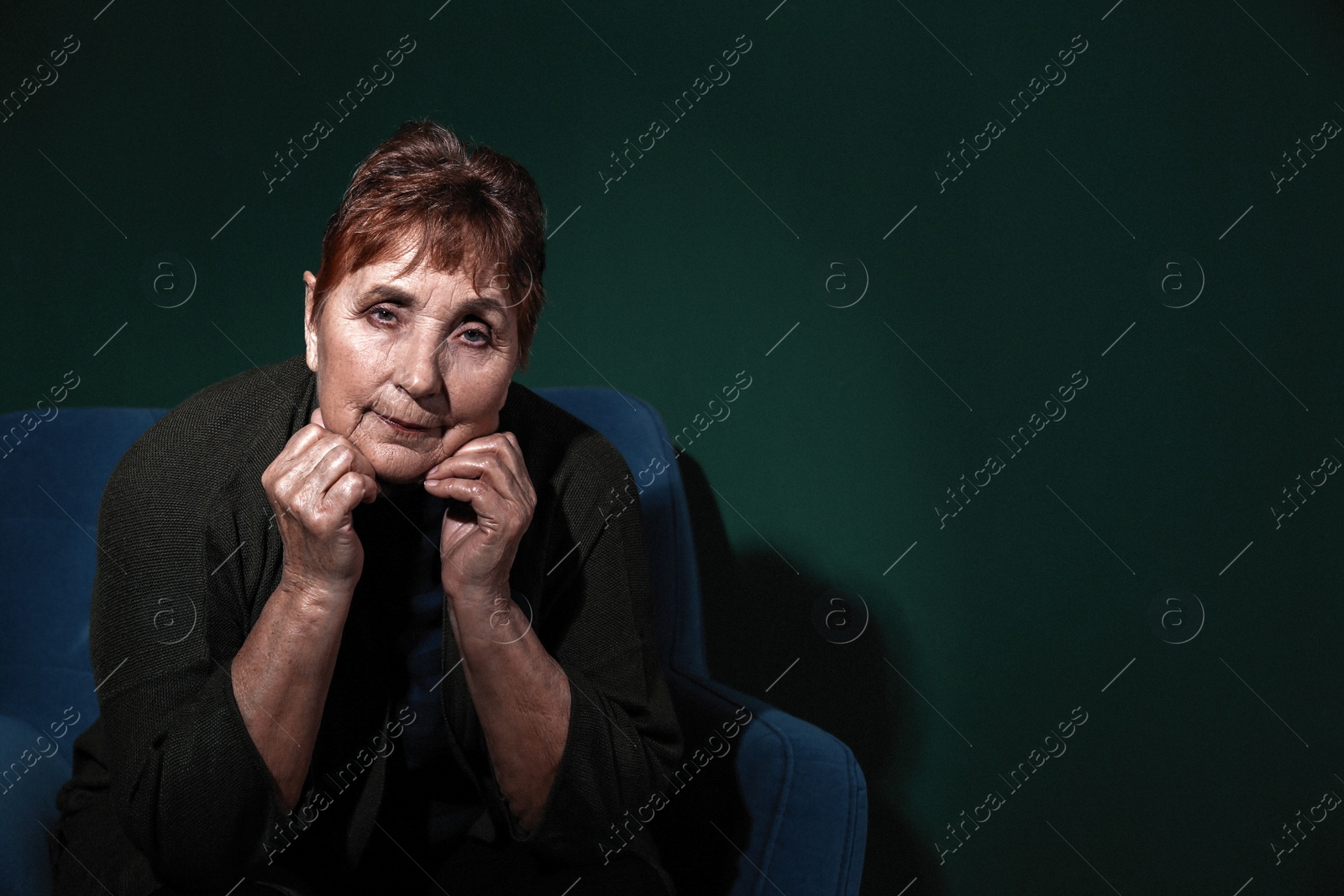Photo of Portrait of poor senior woman on color background. Space for text