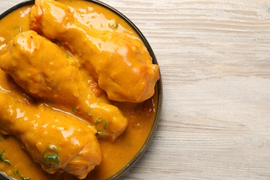 Tasty chicken curry on wooden table, top view. Space for text