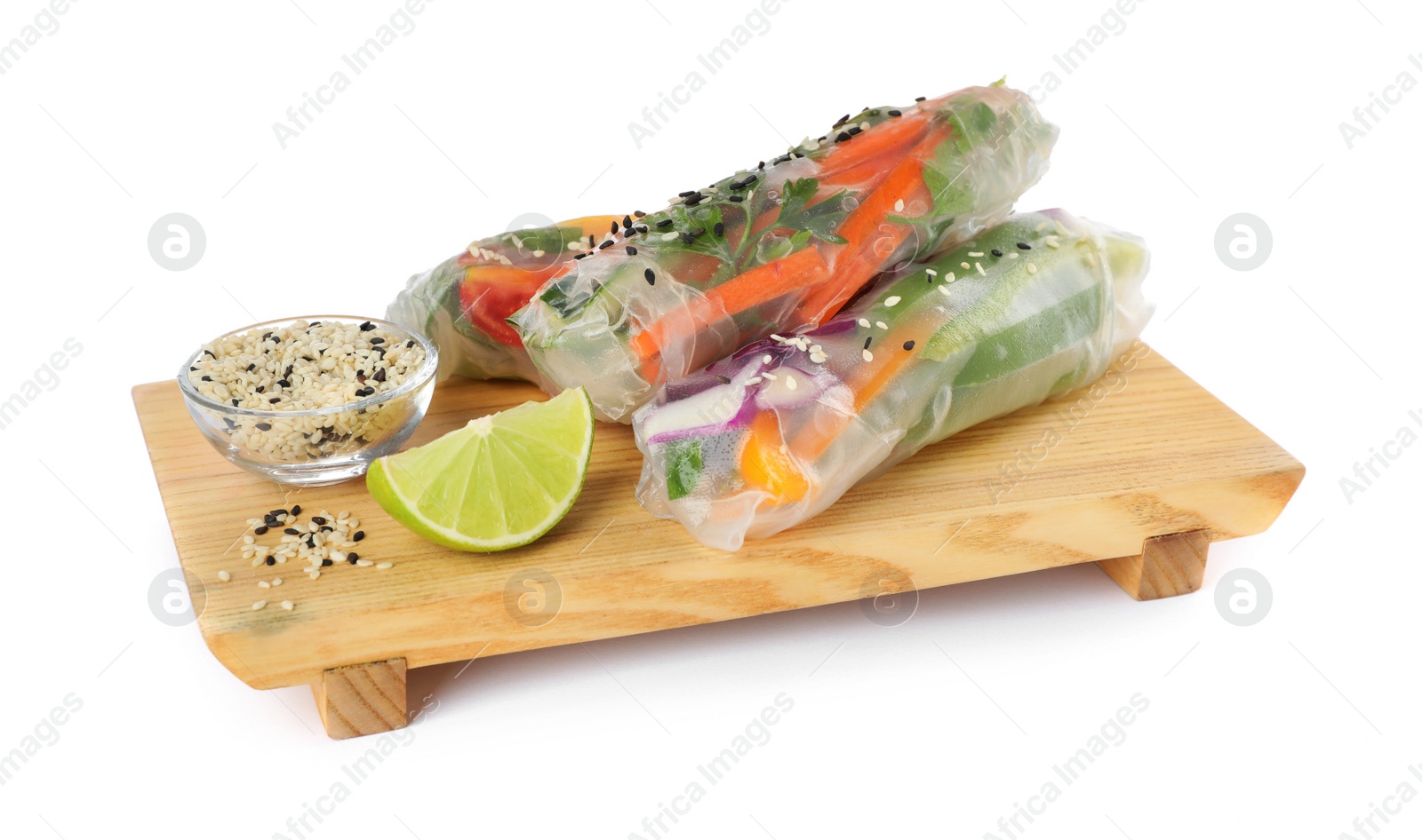 Photo of Serving board with delicious rolls wrapped in rice paper on white background