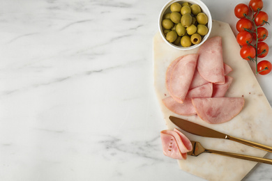 Tasty ham served on white marble table, flat lay. Space for text