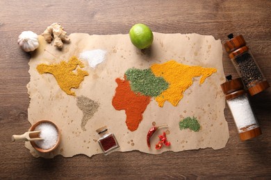 World map of different spices and products on wooden table, top view