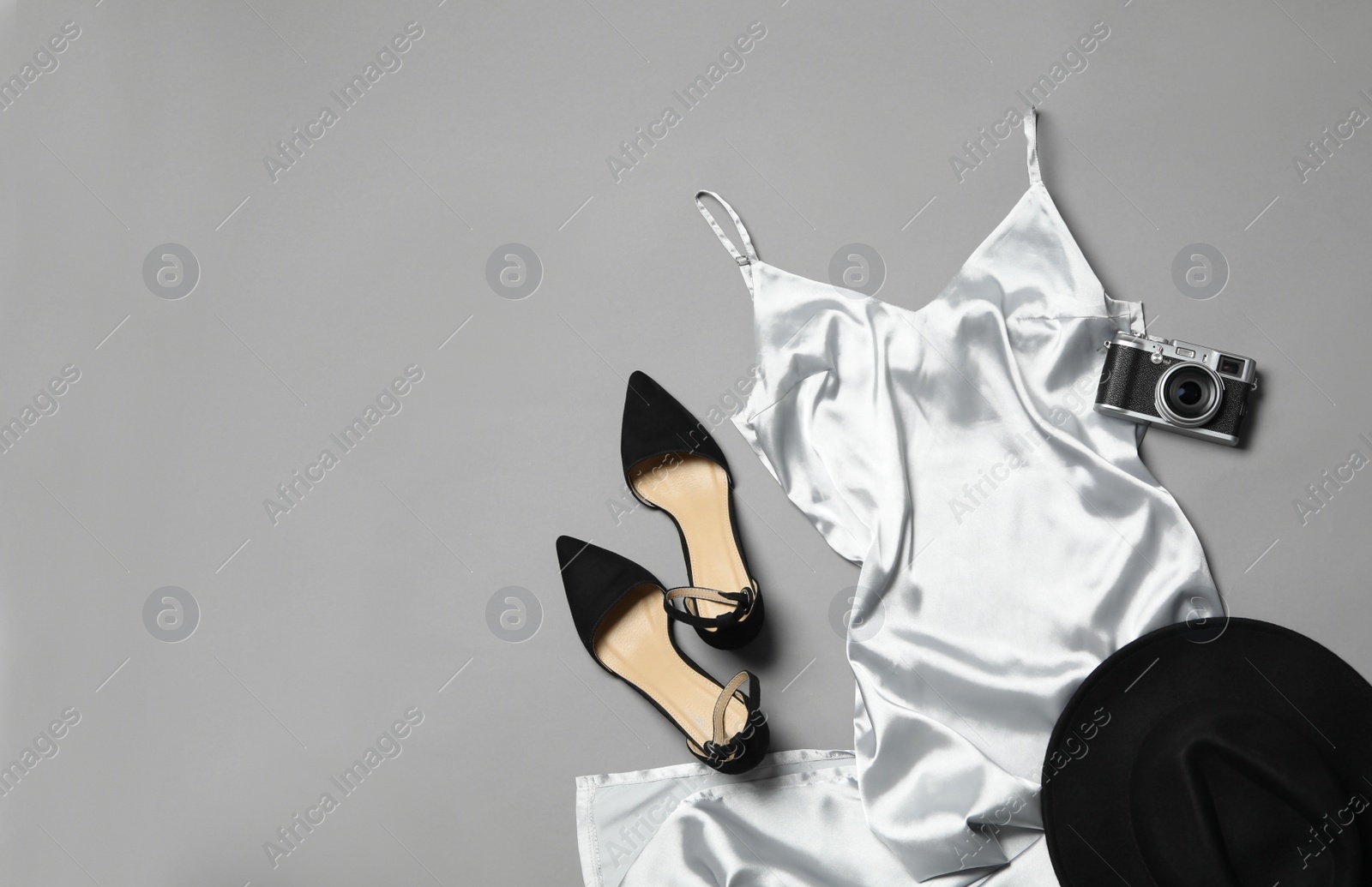 Photo of Flat lay composition with stylish white dress on grey background. Space for text