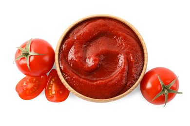 Tasty ketchup in wooden bowl and fresh tomatoes isolated on white, top view