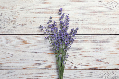 Photo of Beautiful fresh lavender flowers on white wooden background, top view