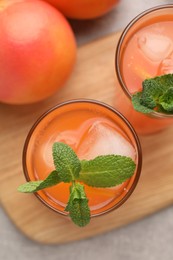 Photo of Tasty freshly made grapefruit juice, fruit and mint on table, top view