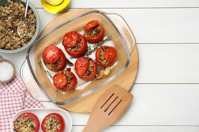 Photo of Delicious stuffed tomatoes with minced beef, bulgur and mushrooms on white wooden table, flat lay. Space for text