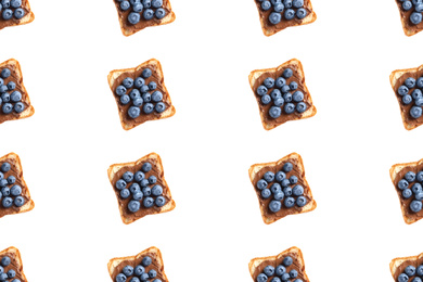 Set of delicious toasted bread with chocolate spread and blueberries on white background, top view