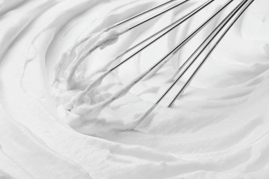 Photo of Whipping white cream with balloon whisk, closeup view