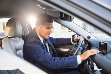 Photo of Handsome man driving his modern luxury car