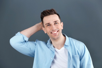 Charming young man on grey background