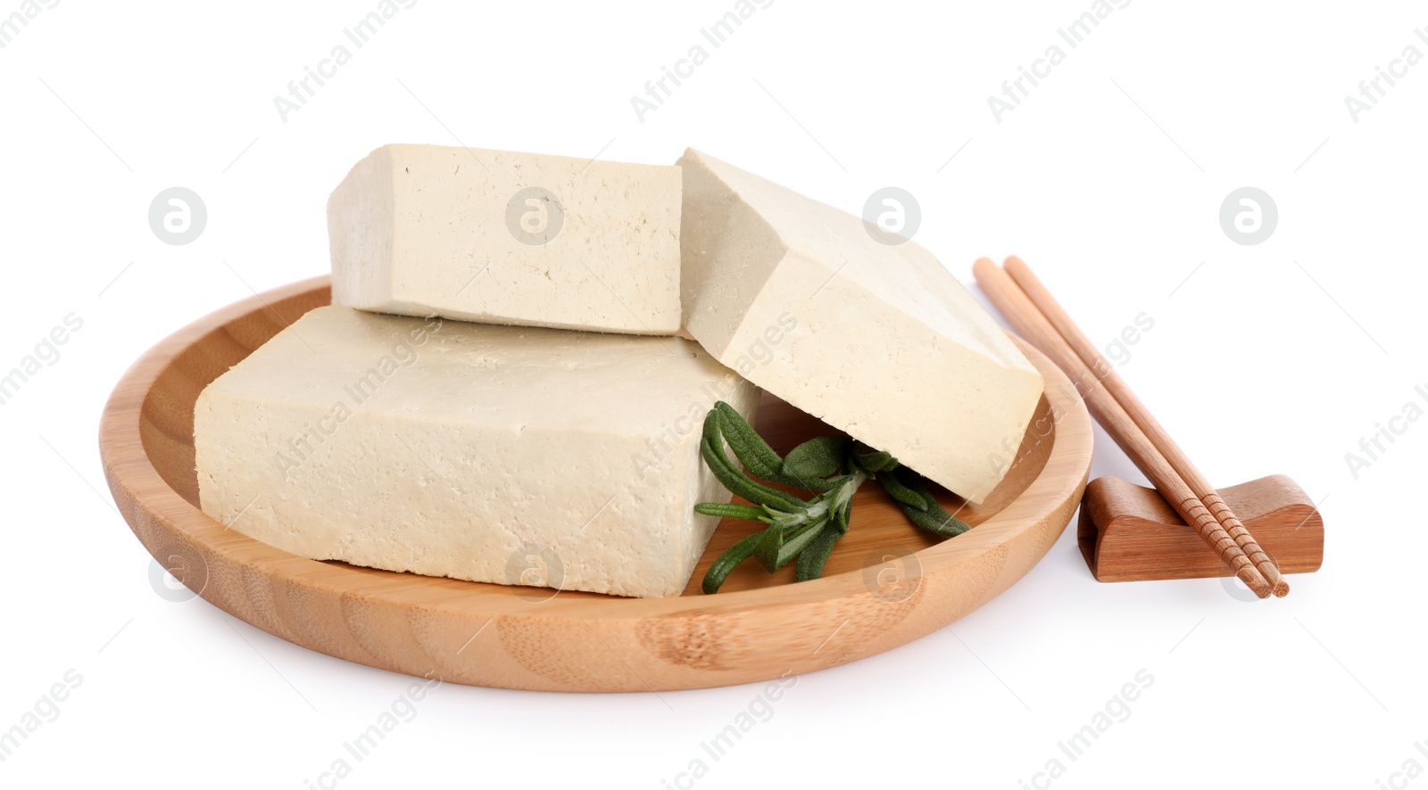 Photo of Wooden plate with delicious raw tofu, rosemary and chopsticks on white background