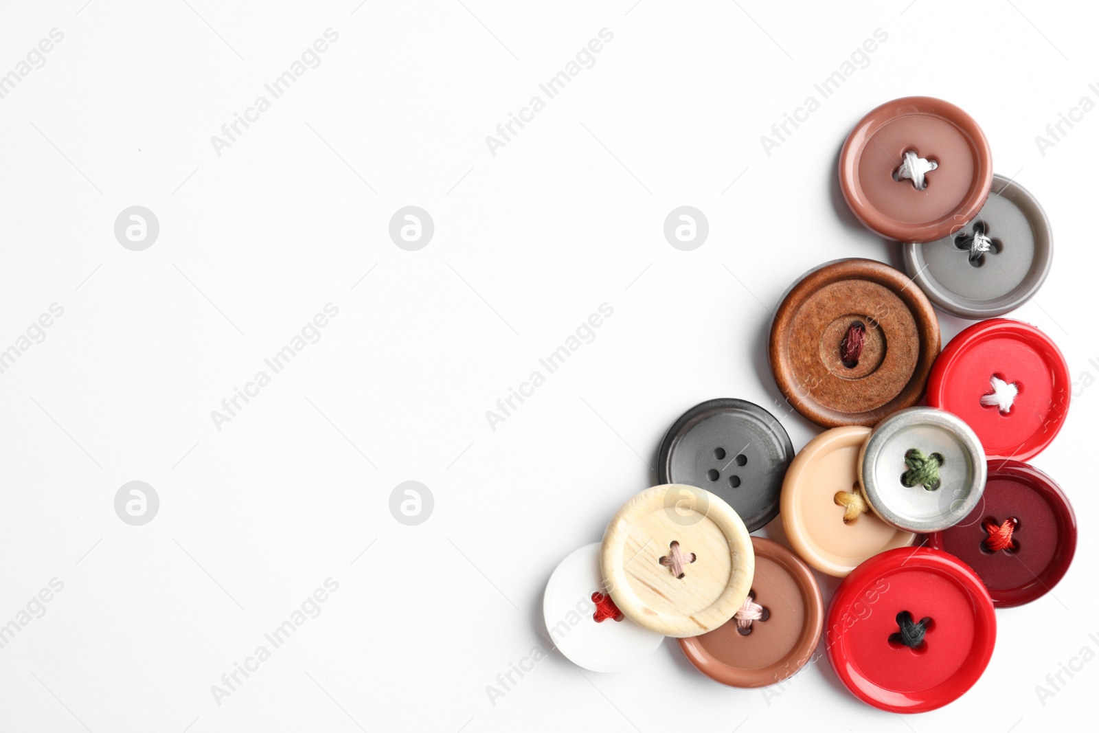 Photo of Many colorful sewing buttons on white background, top view