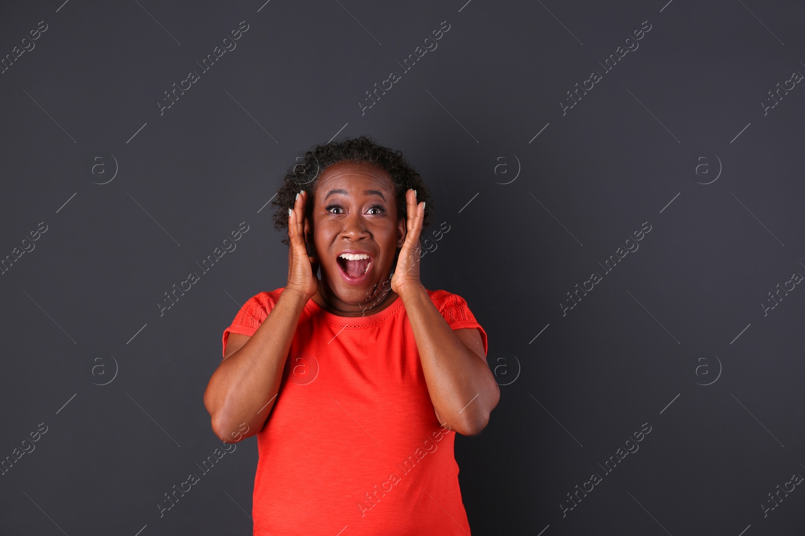Photo of Portrait of happy African-American woman on black background