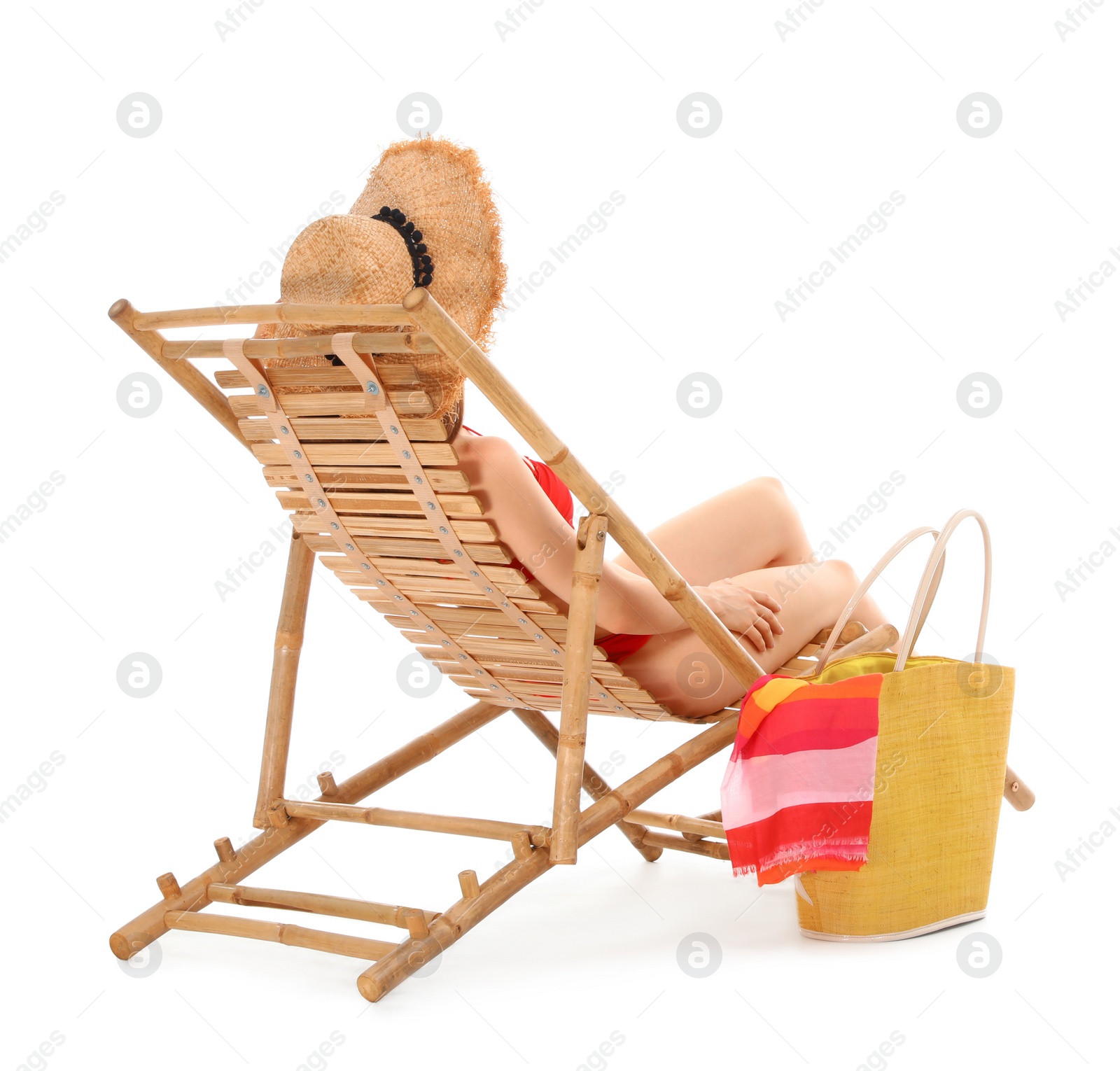 Photo of Young woman with beach accessories on sun lounger against white background