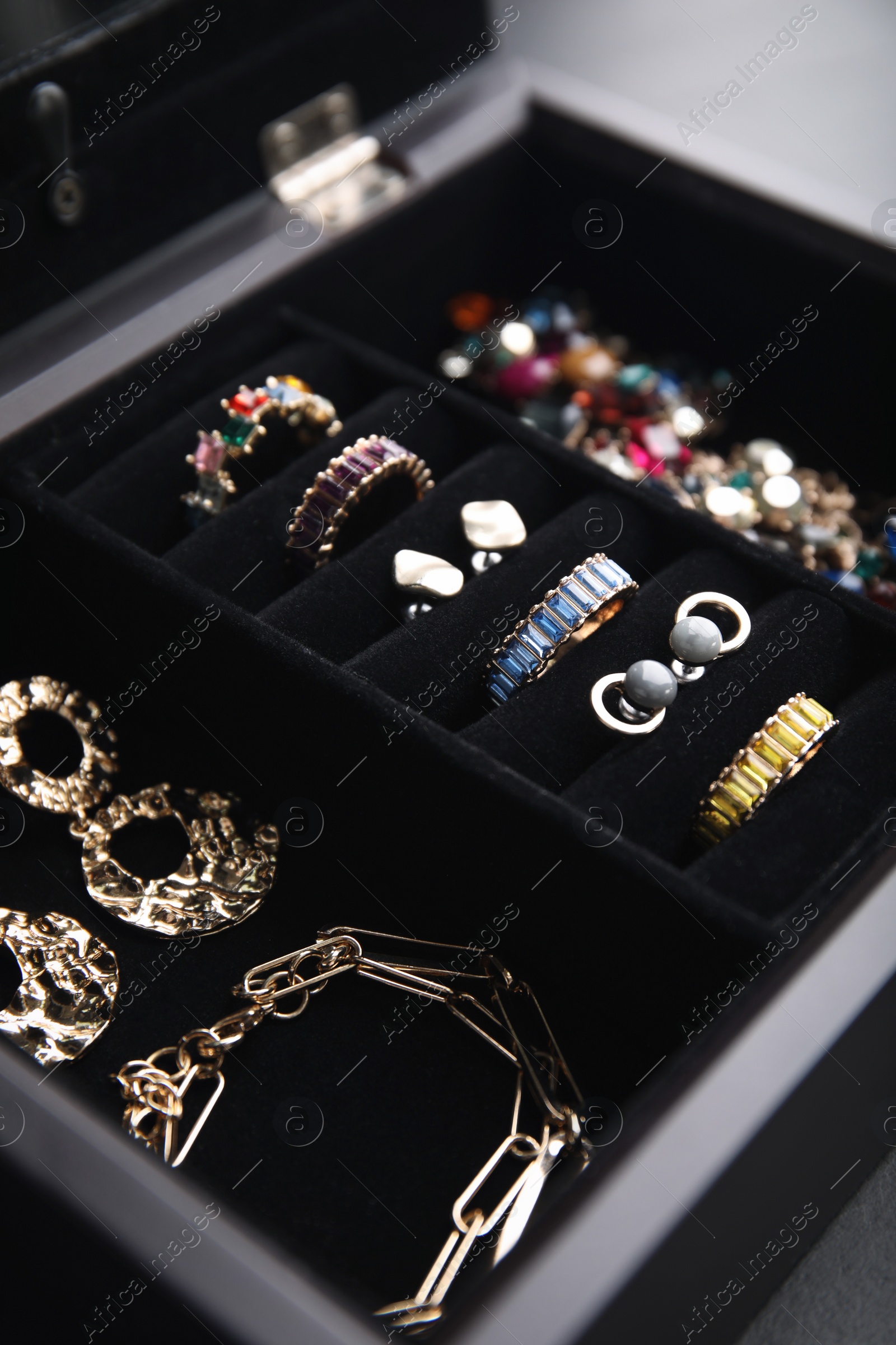 Photo of Jewelry box with stylish bijouterie on table, closeup