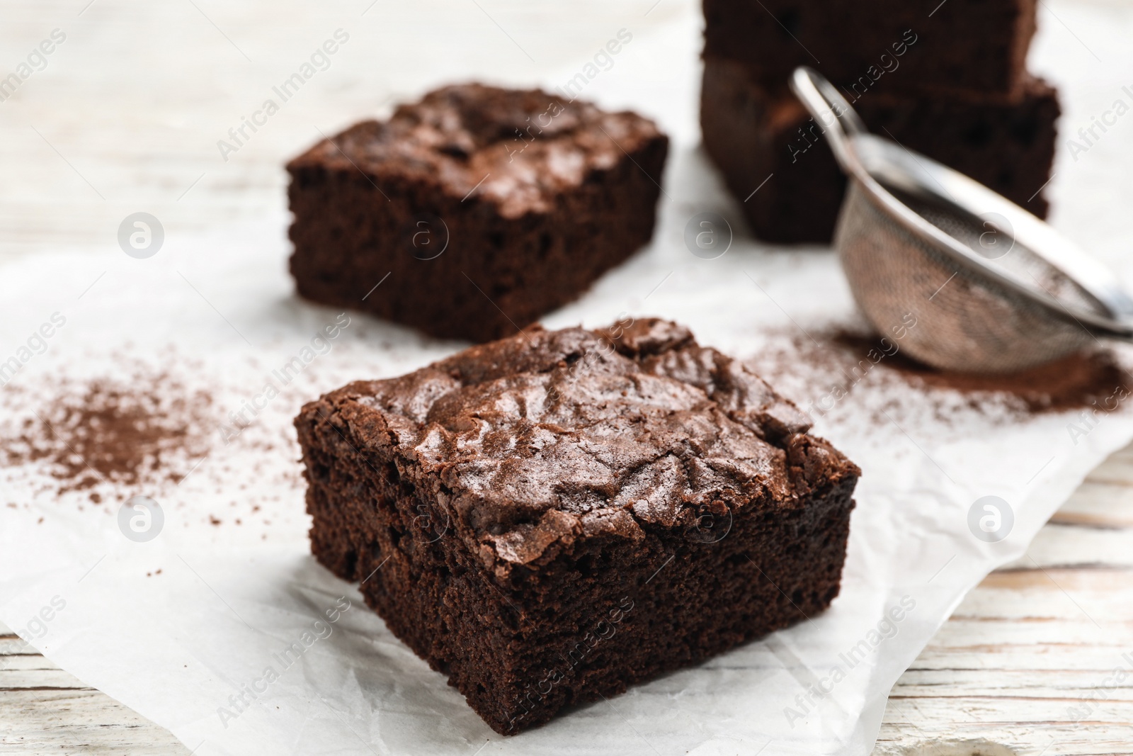 Photo of Fresh homemade brownies on table, closeup. Delicious chocolate pie