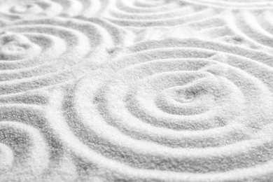 White sand with pattern as background. Zen, meditation, harmony