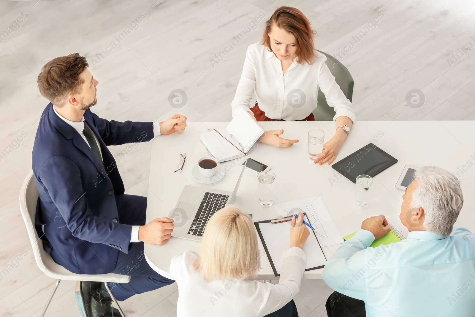 Photo of Group of people discussing ideas at table in office. Consulting service concept