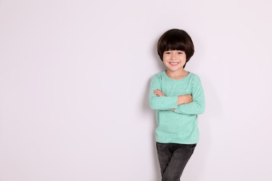 Portrait of cute little boy on white background, space for text