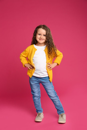 Photo of Full length portrait of cute little girl on pink background