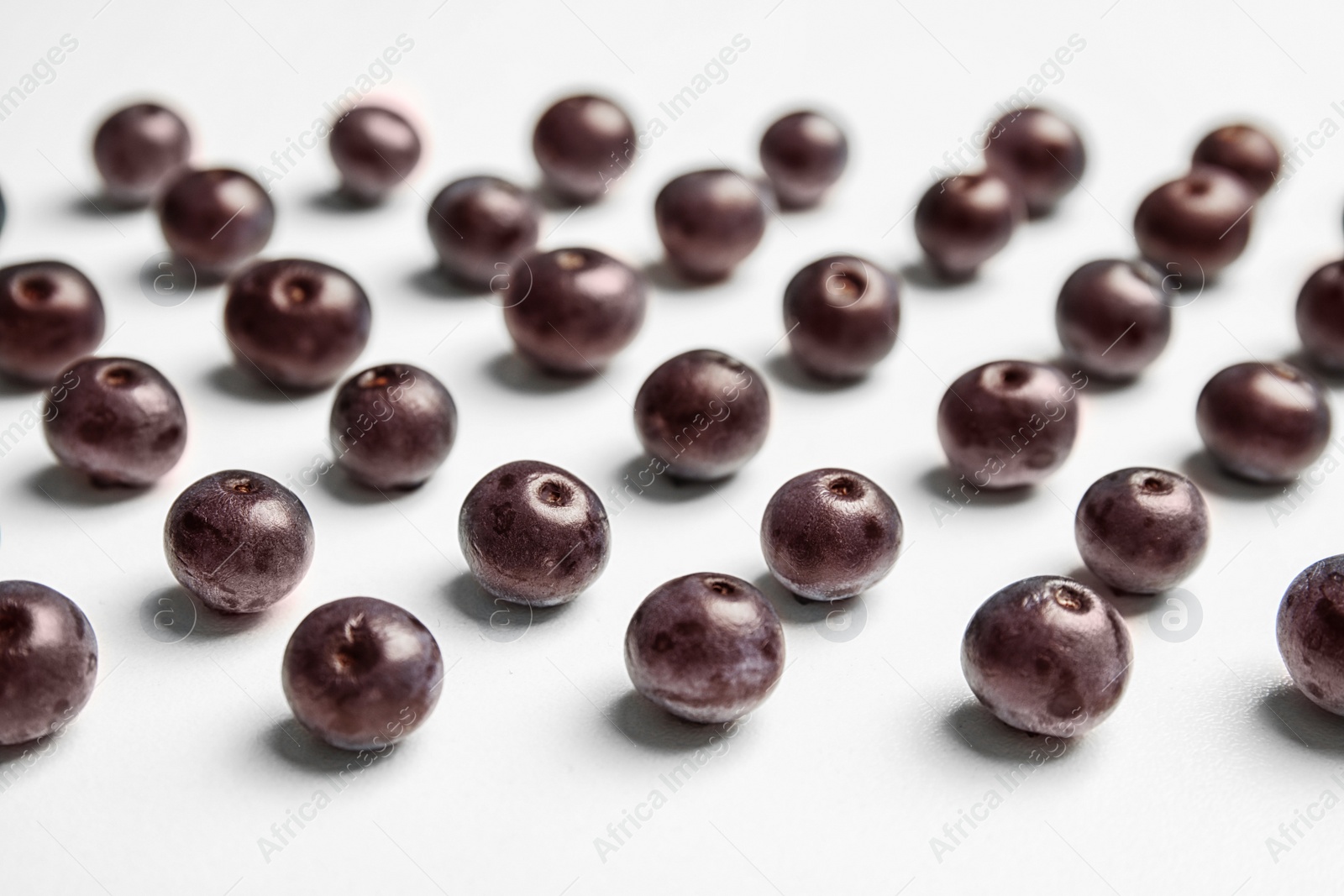 Photo of Fresh acai berries on white background