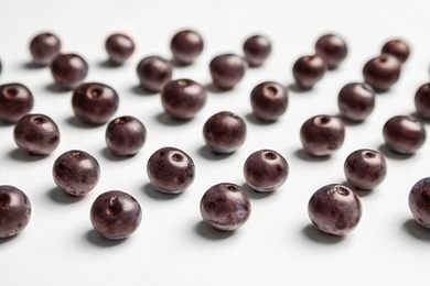 Fresh acai berries on white background