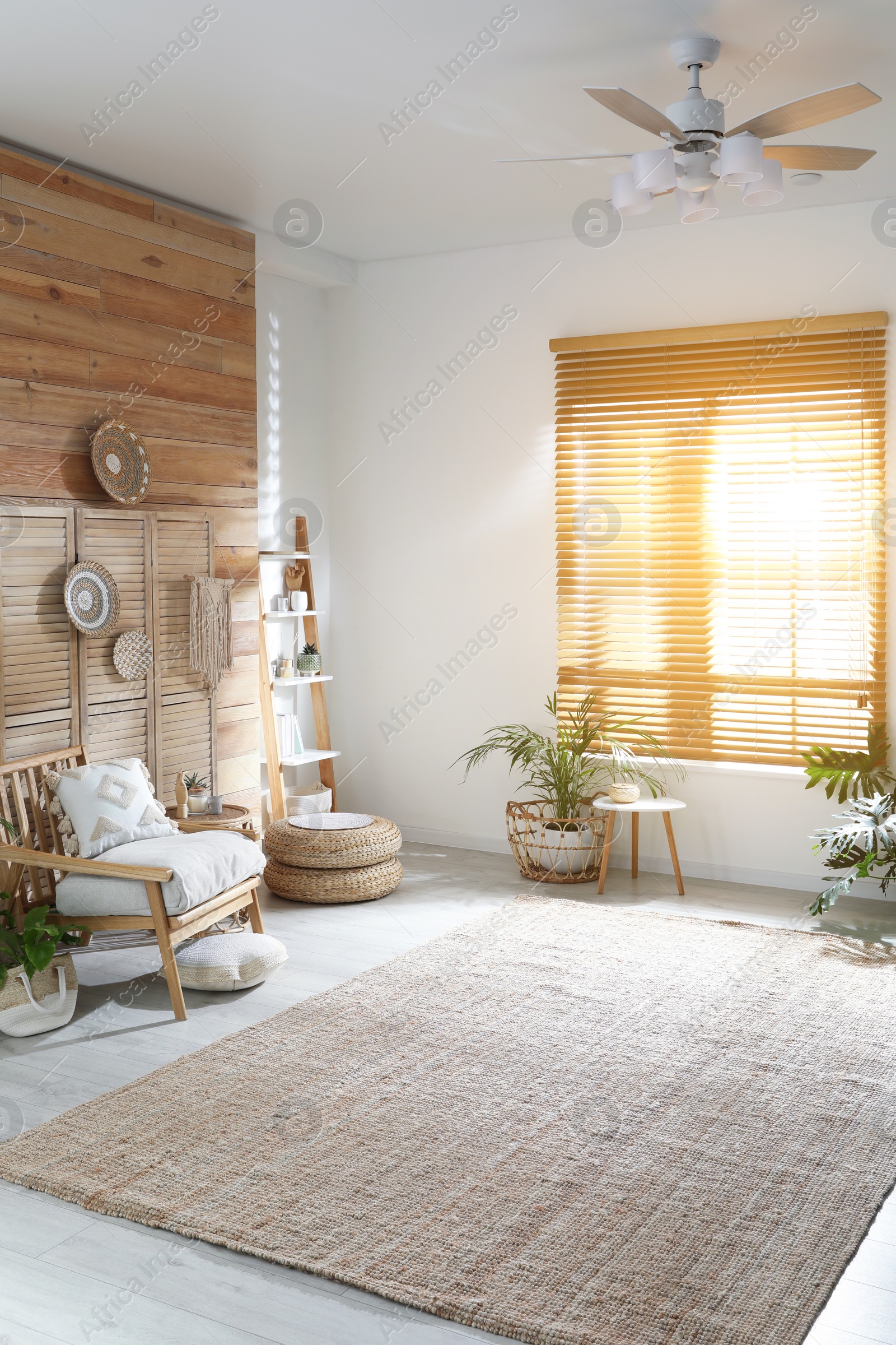 Photo of Stylish living room interior with comfortable wooden armchair and beautiful houseplants