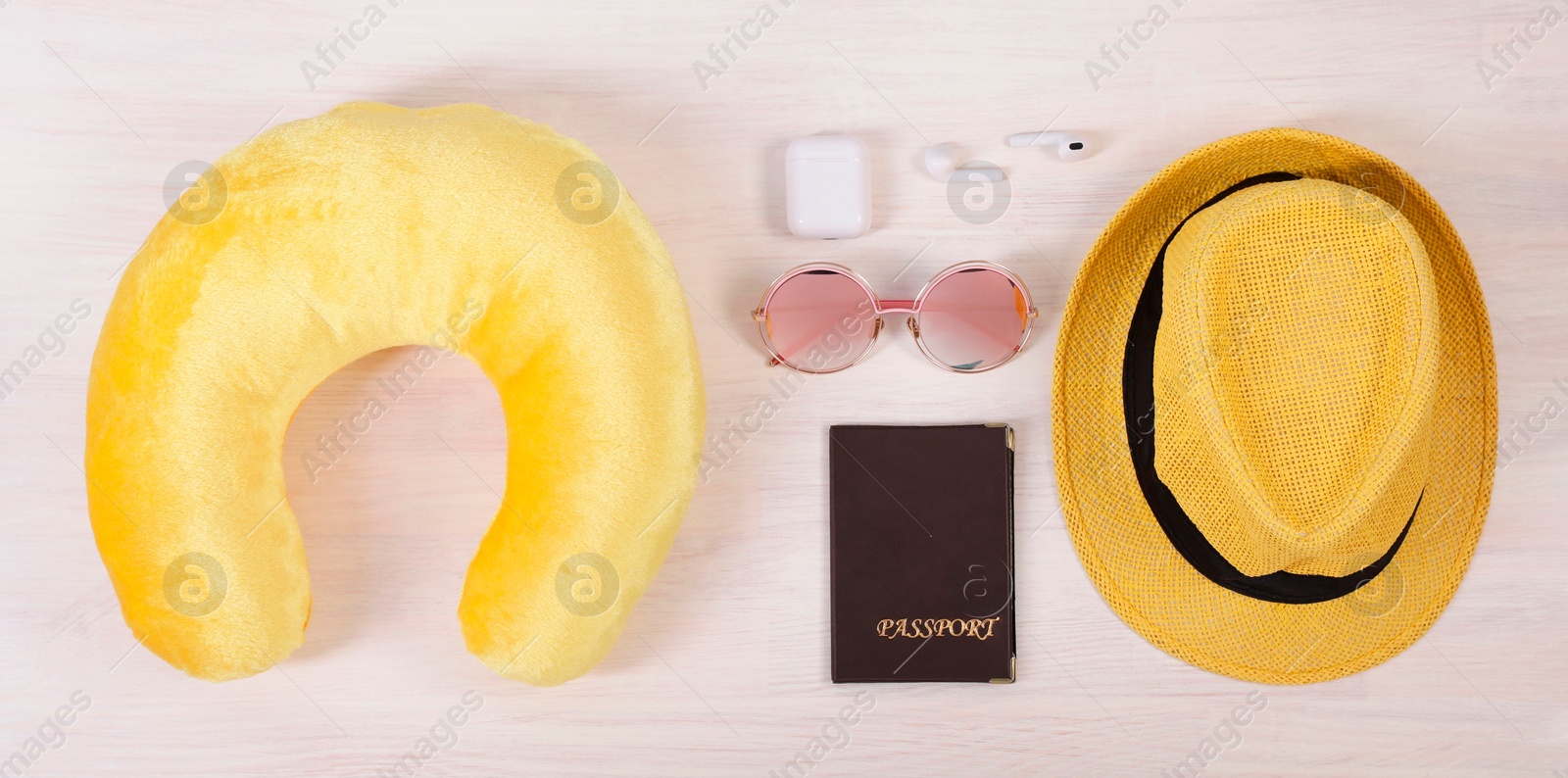 Photo of Flat lay composition with yellow travel pillow on white wooden background