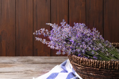 Photo of Bowl with lavender flowers on wooden table