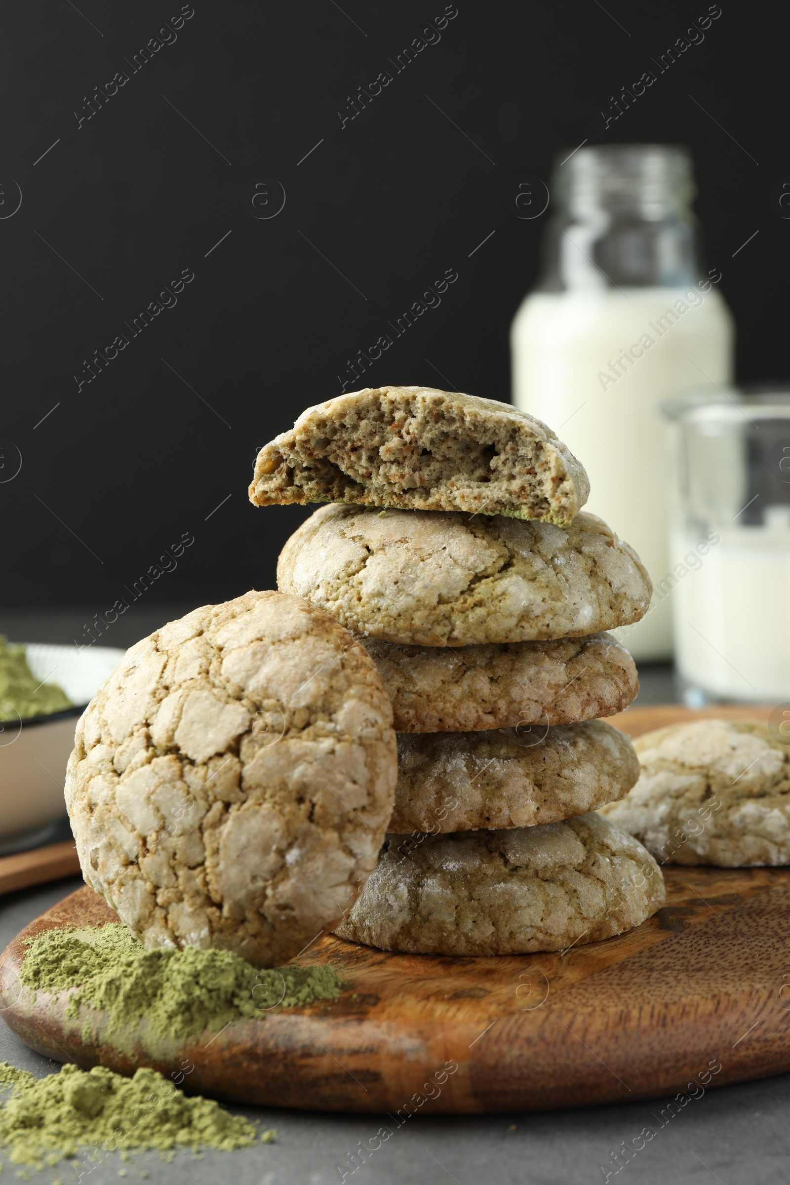 Photo of Tasty matcha cookies and powder on grey table
