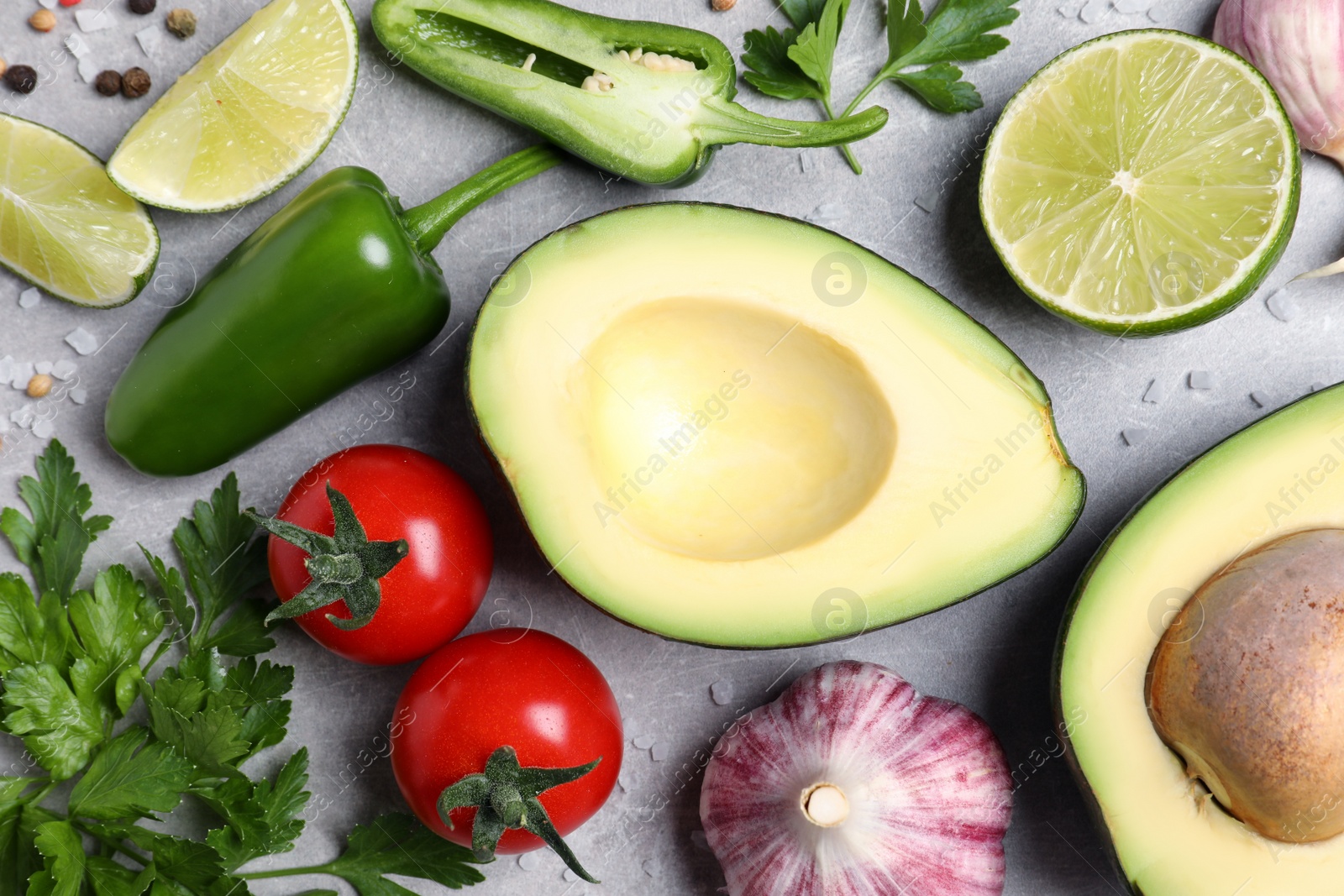 Photo of Fresh ingredients for guacamole on light grey table, flat lay
