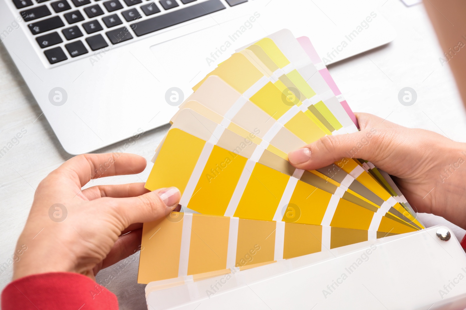 Photo of Woman with palette samples at white table, closeup