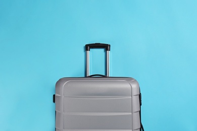 Photo of Stylish suitcase on color background, top view