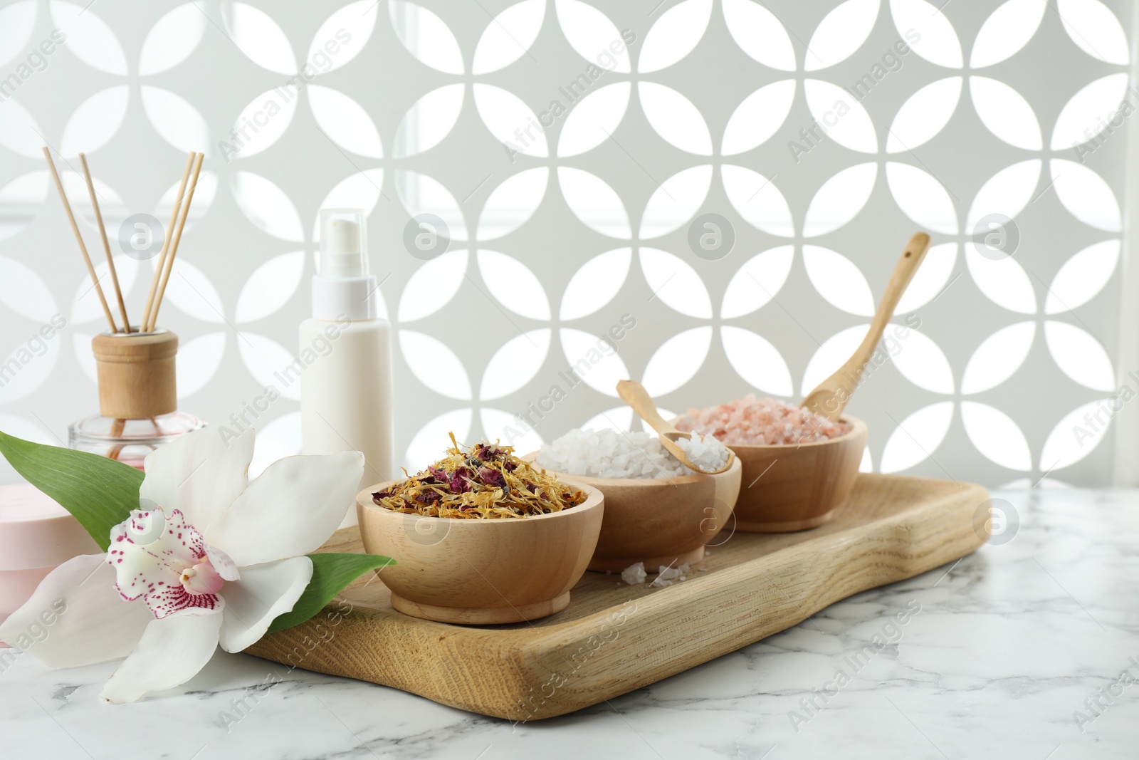 Photo of Beautiful composition with different spa products and orchid on white marble table