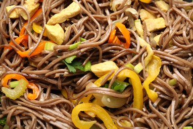 Photo of Stir-fry. Tasty noodles with vegetables and meat as background, closeup