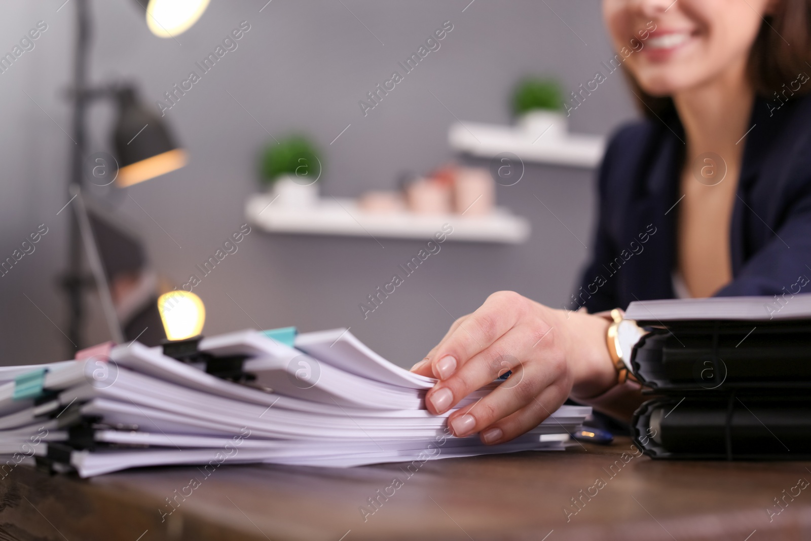 Photo of Businesswoman working with documents at office table, closeup. Space for text