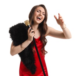 Beautiful young woman in stylish red dress with microphone singing on white background