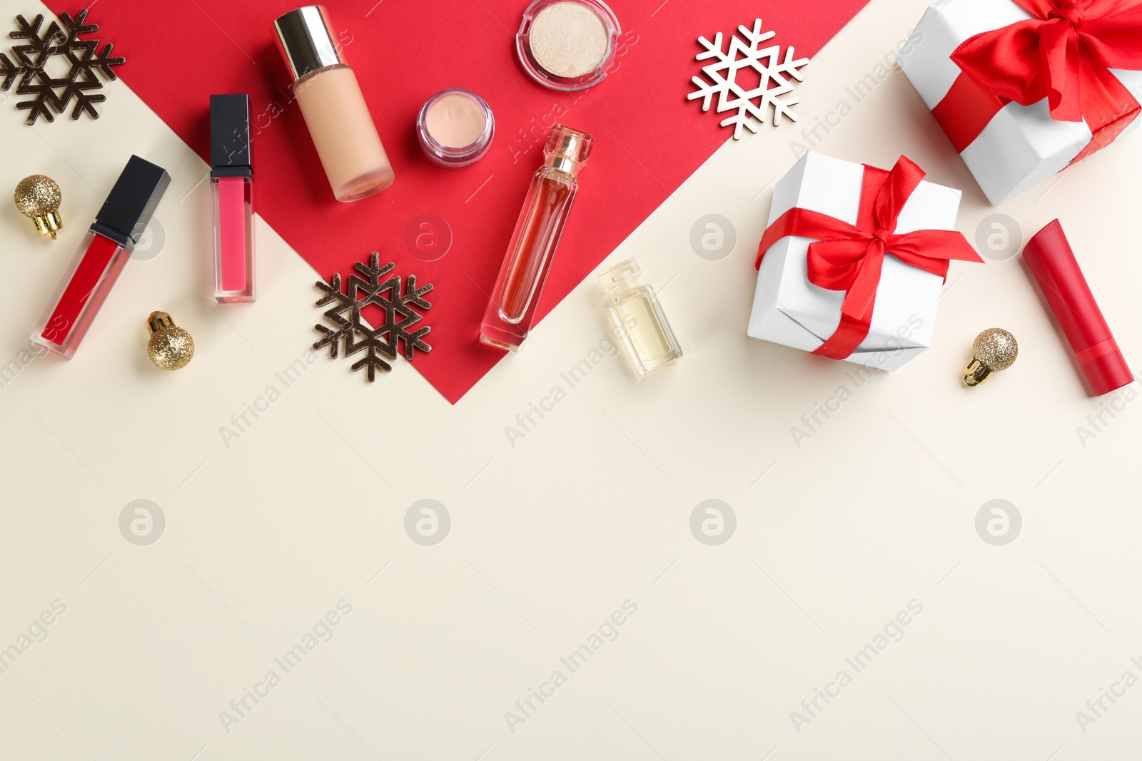 Photo of Flat lay composition with decorative cosmetic products on color background, space for text. Winter care