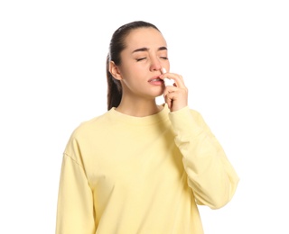 Photo of Woman using nasal spray on white background