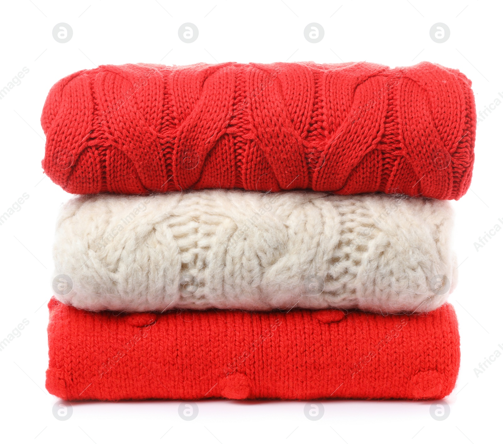 Photo of Stack of folded knitted sweaters on white background