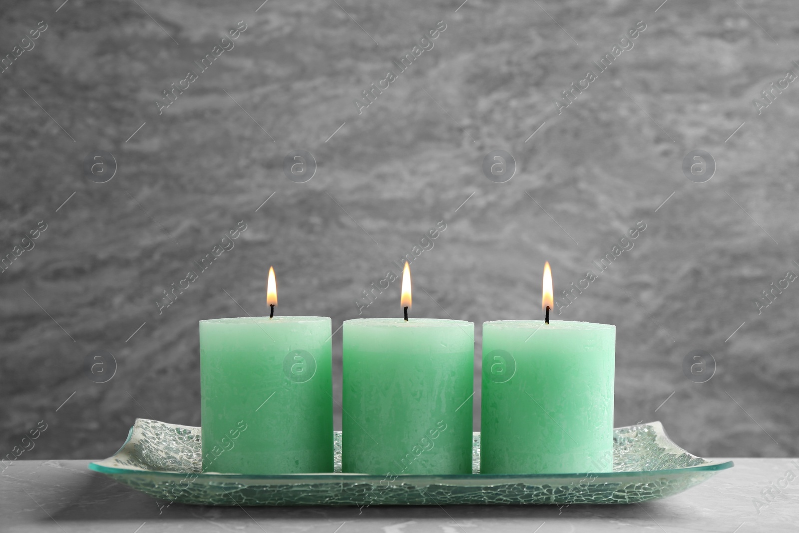 Photo of Composition with three burning candles on table. Space for text