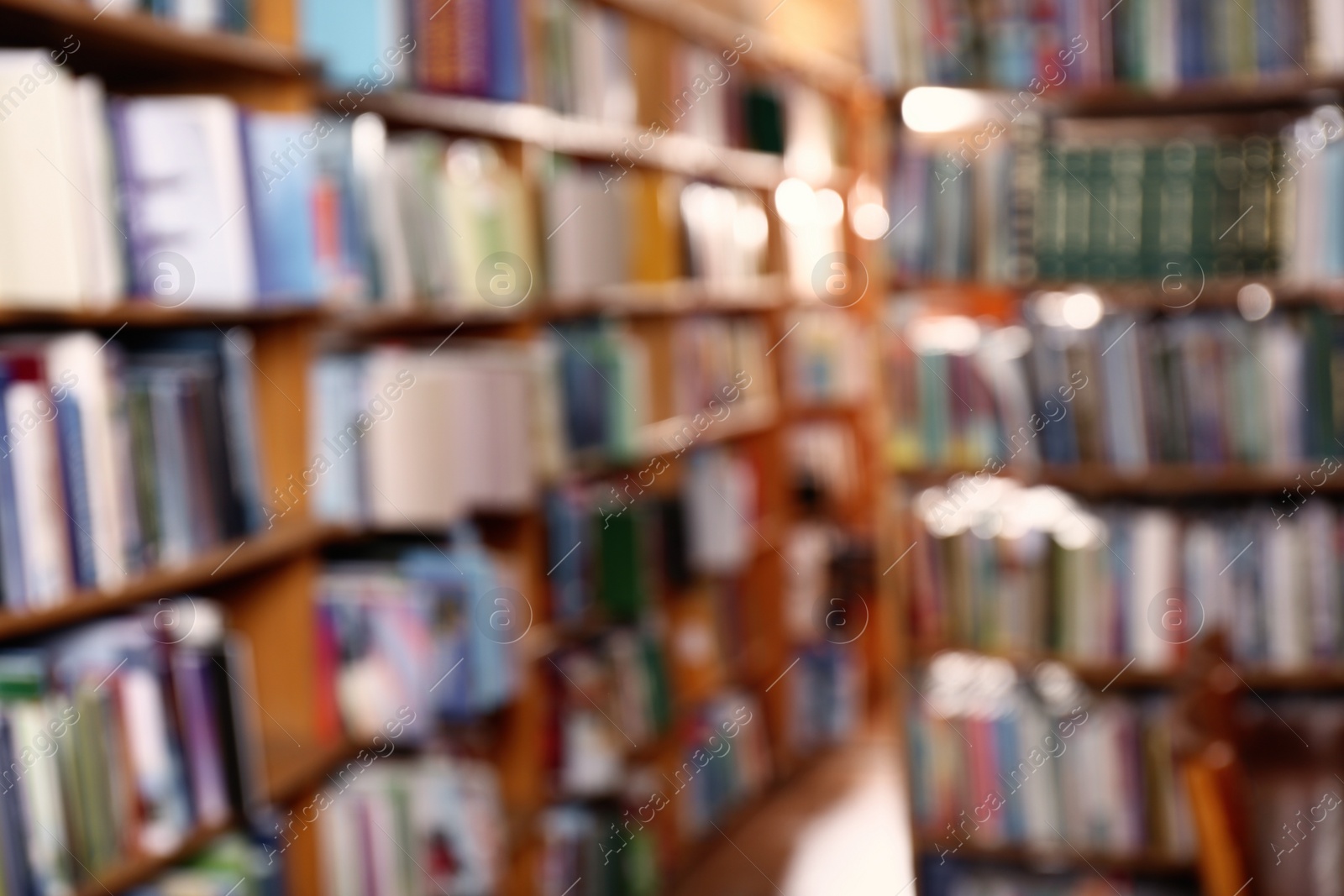 Photo of Blurred view of different books on shelves in library