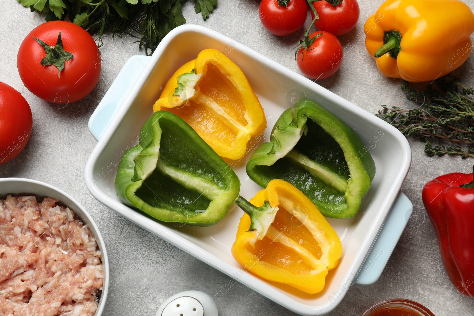 Photo of Making stuffed peppers. Vegetables and ground meat on grey table, flat lay