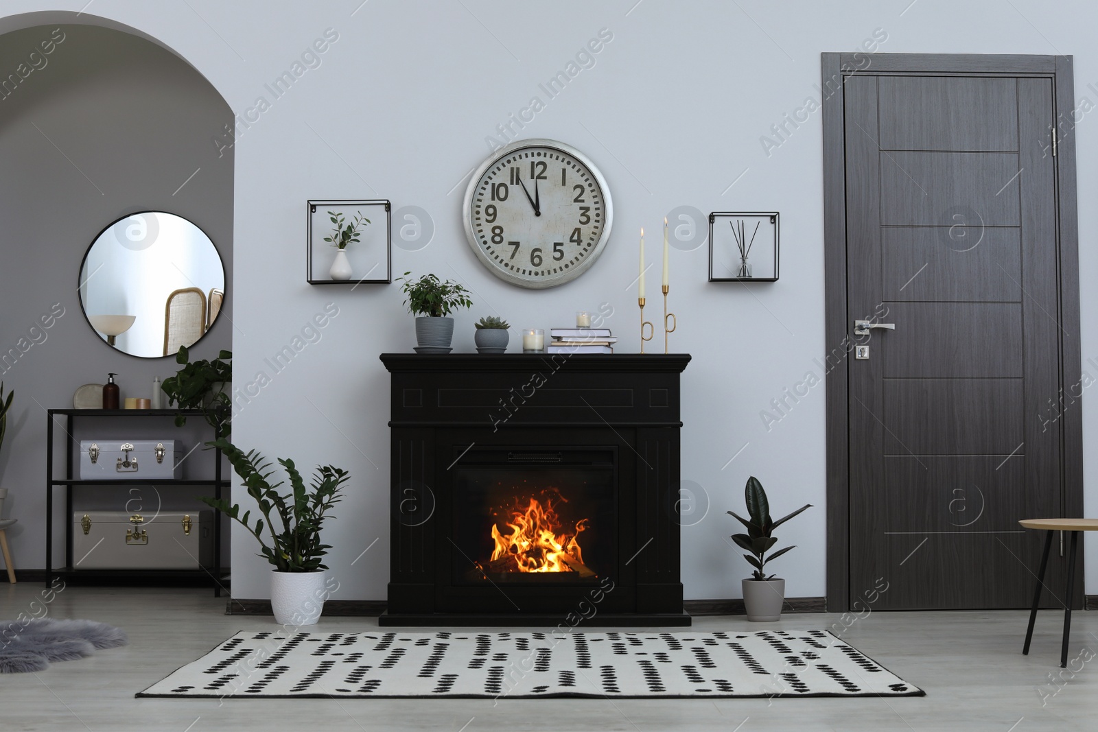 Photo of Stylish living room interior with fireplace and green plants