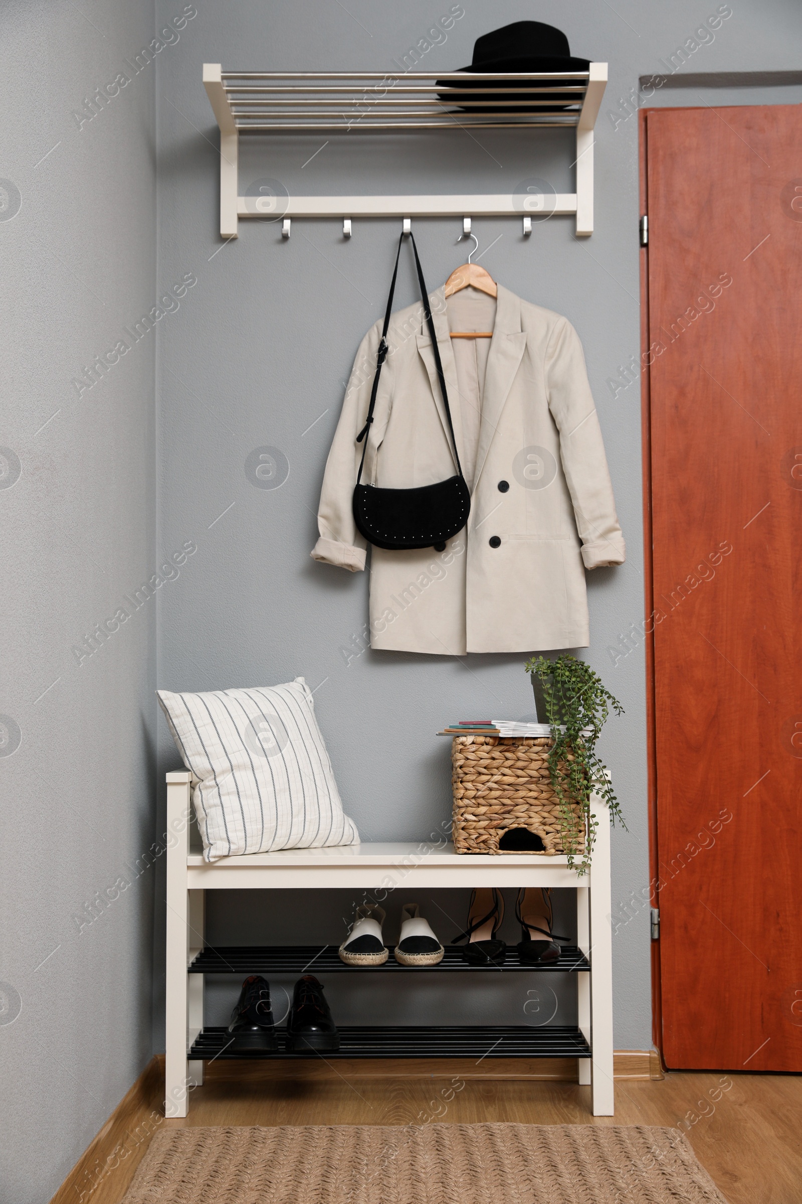 Photo of Modern hallway interior with stylish furniture near wooden door