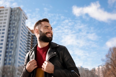 Portrait of stylish young man on city street