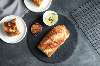 Flat lay composition with tasty homemade garlic bread on table