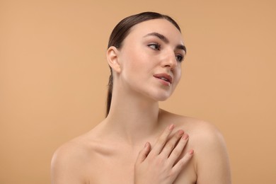 Portrait of beautiful woman on beige background